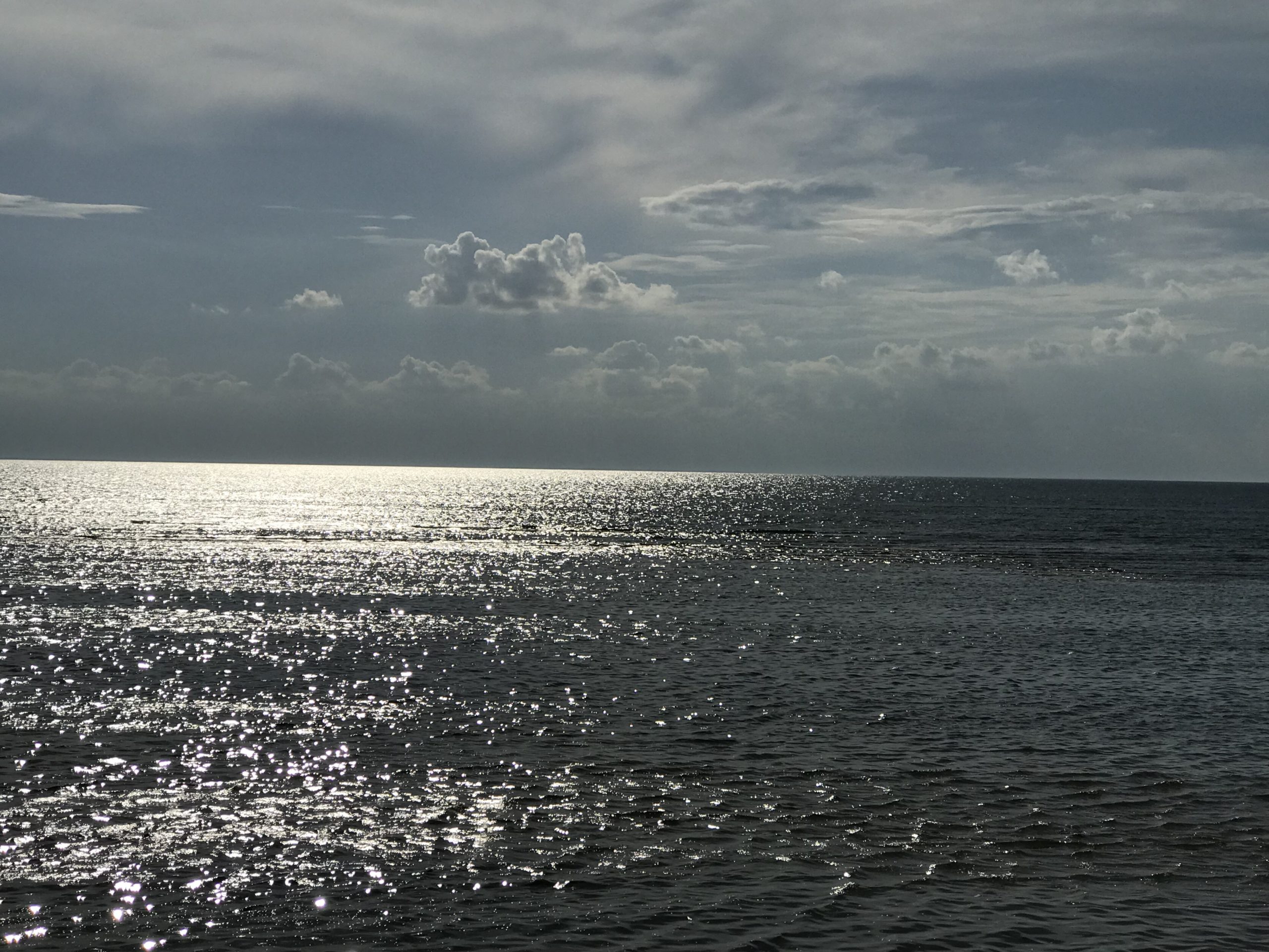 big waterviews with sparkling siver water with clouds 2019